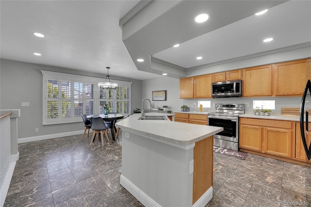19731 E 40th Ave, Denver, CO 80249 - kitchen featuring stainless steel appliances, light countertops, a chandelier, recessed lighting, and an island with sink