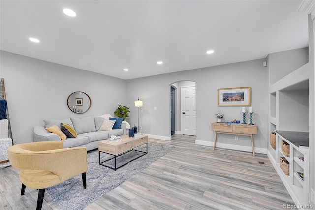 19731 E 40th Ave, Denver, CO 80249 - living room with arched walkways, light wood finished floors, and recessed lighting