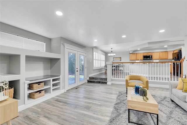 19731 E 40th Ave, Denver, CO 80249 - living room featuring recessed lighting, french doors, light wood finished floors, and a chandelier