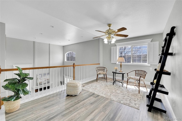 19731 E 40th Ave, Denver, CO 80249 - sitting room with wood finished floors, plenty of natural light, and a ceiling fan