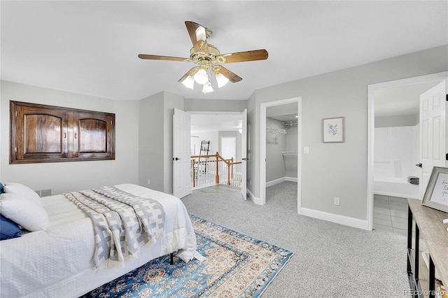 19731 E 40th Ave, Denver, CO 80249 - carpeted bedroom with a spacious closet, ceiling fan, connected bathroom, and a closet