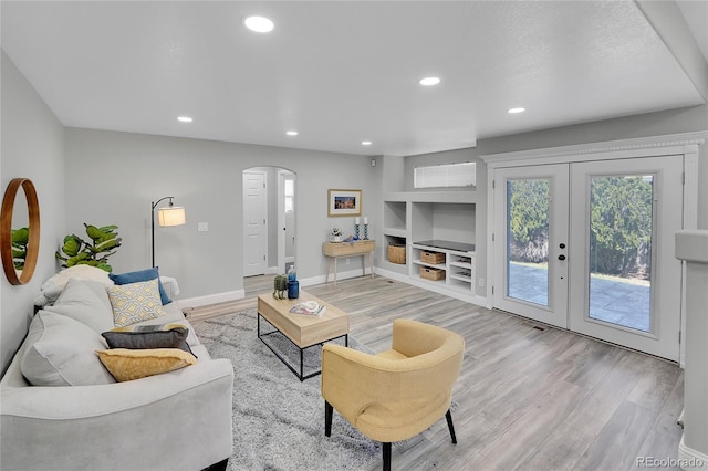 19731 E 40th Ave, Denver, CO 80249 - living room with arched walkways, light wood-style floors, built in features, plenty of natural light, and recessed lighting