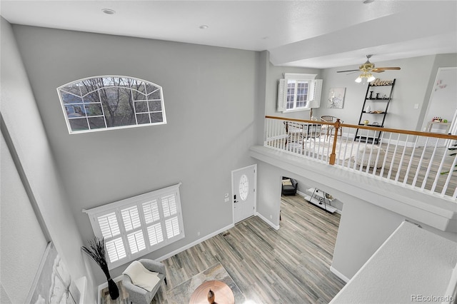 19731 E 40th Ave, Denver, CO 80249 - living room with wood finished floors, a ceiling fan, and a high ceiling