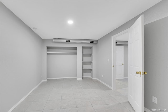 19731 E 40th Ave, Denver, CO 80249 - unfurnished bedroom with light tile patterned flooring and a closet