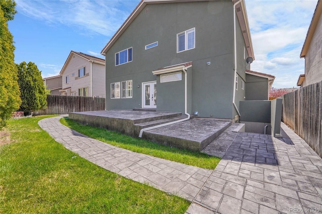 19731 E 40th Ave, Denver, CO 80249 - rear view of property with french doors, a patio, stucco siding, and a fenced backyard