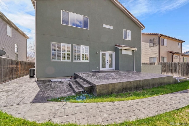 19731 E 40th Ave, Denver, CO 80249 - rear view of house featuring french doors, a patio, a fenced backyard, and stucco siding