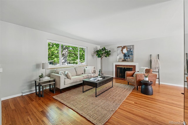 1905 S Linden Ct, Denver, CO 80224 - living area featuring baseboard heating, light wood finished floors, and a fireplace