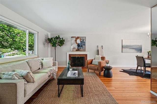 1905 S Linden Ct, Denver, CO 80224 - living room with wood finished floors and a brick fireplace