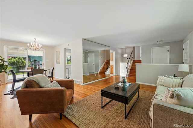 1905 S Linden Ct, Denver, CO 80224 - living area featuring stairs, plenty of natural light, a chandelier, and light wood-style flooring