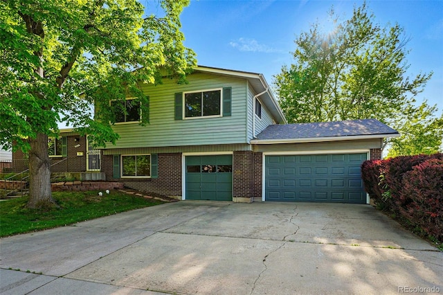 1905 S Linden Ct, Denver, CO 80224 - split level home featuring concrete driveway, brick siding, and an attached garage