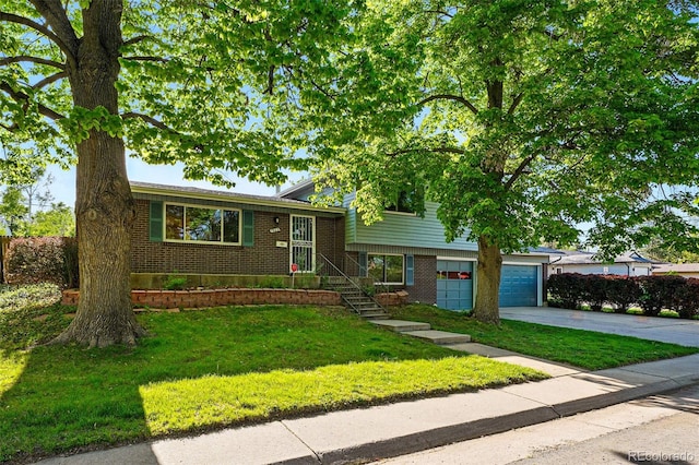 1905 S Linden Ct, Denver, CO 80224 - tri-level home featuring brick siding, concrete driveway, a front lawn, and an attached garage