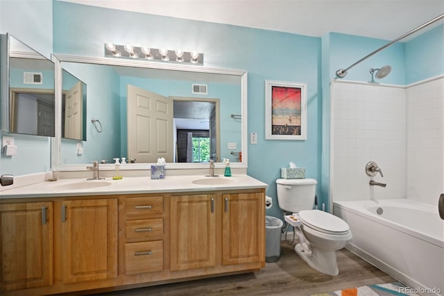 full bathroom with vanity, toilet, wood-type flooring, and shower / tub combination