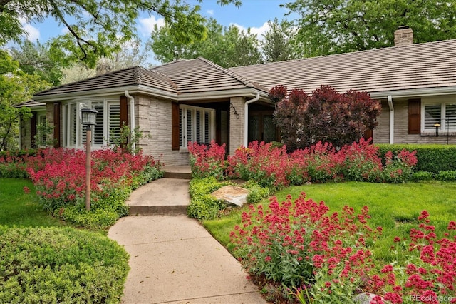 5340 S Logan Dr, Greenwood Village, CO 80121 - ranch-style house with a tile roof, a front lawn, a chimney, and brick siding