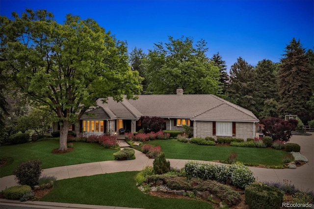 5340 S Logan Dr, Greenwood Village, CO 80121 - view of front of house featuring a tiled roof, a front yard, and a chimney