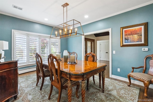 5340 S Logan Dr, Greenwood Village, CO 80121 - dining room with baseboard heating, wood finished floors, ornamental molding, a chandelier, and baseboards
