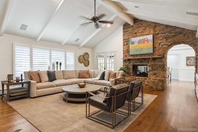 5340 S Logan Dr, Greenwood Village, CO 80121 - living area featuring wood finished floors, arched walkways, ceiling fan, and a stone fireplace