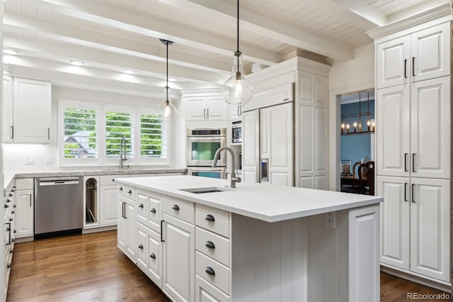 5340 S Logan Dr, Greenwood Village, CO 80121 - kitchen with stainless steel appliances, a center island with sink, beam ceiling, white cabinets, and light countertops