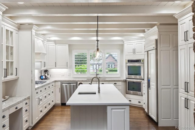 5340 S Logan Dr, Greenwood Village, CO 80121 - kitchen with stainless steel appliances, beam ceiling, a sink, light countertops, and dark wood-style floors