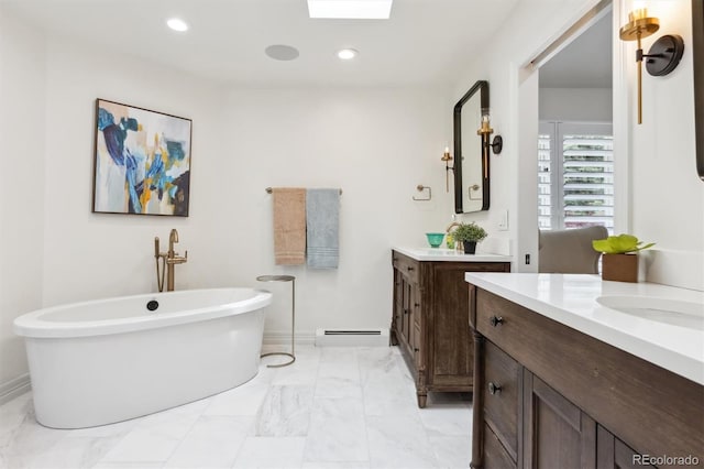 5340 S Logan Dr, Greenwood Village, CO 80121 - bathroom featuring two vanities, a soaking tub, baseboard heating, marble finish floors, and baseboards