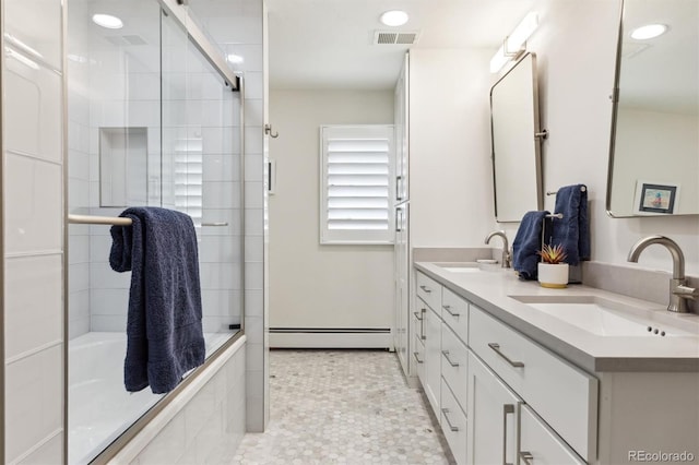 5340 S Logan Dr, Greenwood Village, CO 80121 - bathroom with a baseboard heating unit, double vanity, tiled shower / bath, and recessed lighting