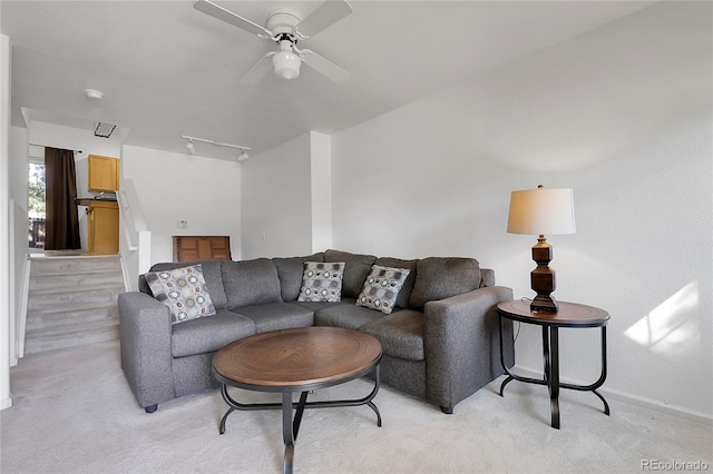 14496 E Tufts Pl Unit C, Aurora, CO 80015 - living room with light colored carpet, ceiling fan, and stairs