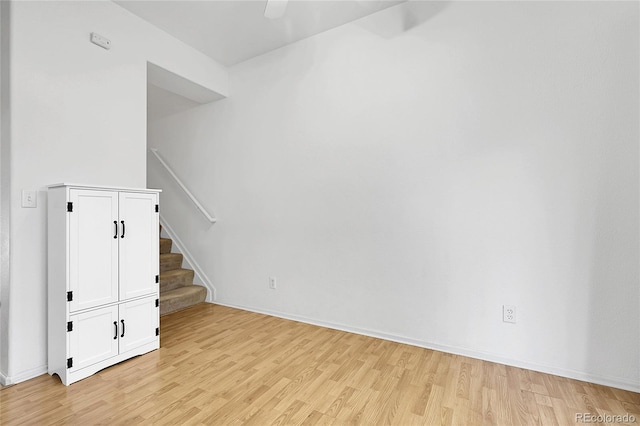 14496 E Tufts Pl Unit C, Aurora, CO 80015 - empty room with light wood-style floors, stairs, and ceiling fan
