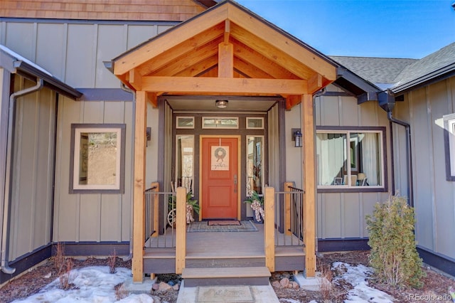 entrance to property with board and batten siding and roof with shingles