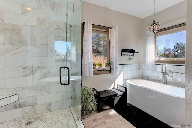 505 Rd P69, Bailey, CO 80421 - full bath with wood finished floors, a stall shower, a notable chandelier, and a soaking tub