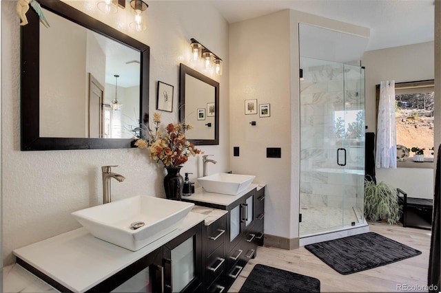 505 Rd P69, Bailey, CO 80421 - full bathroom with wood finished floors, a sink, and a stall shower