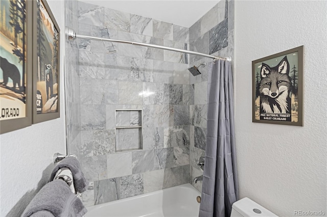 505 Rd P69, Bailey, CO 80421 - full bath featuring a textured wall, toilet, and shower / tub combo with curtain