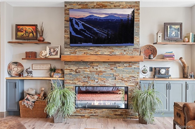 505 Rd P69, Bailey, CO 80421 - living room with a glass covered fireplace and wood finished floors