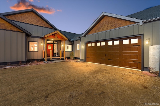 505 Rd P69, Bailey, CO 80421 - view of front of property featuring an attached garage, board and batten siding, driveway, and roof with shingles