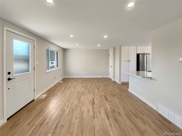 unfurnished living room featuring light wood-type flooring