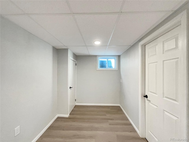 basement featuring hardwood / wood-style floors and a drop ceiling