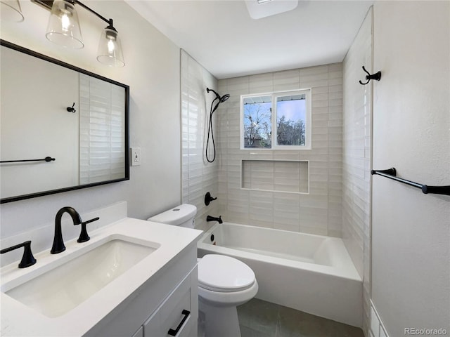 full bathroom featuring toilet, vanity, and tiled shower / bath