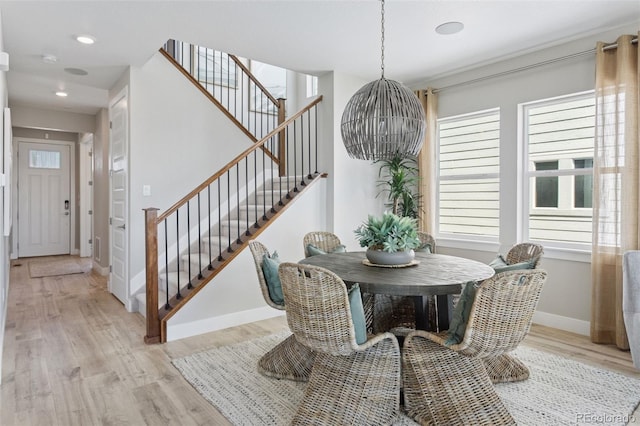 13334 Blue Amber Ct, Parker, CO 80134 - dining room with stairs, light wood-style floors, a chandelier, and recessed lighting