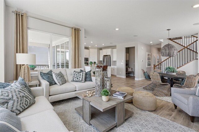 13334 Blue Amber Ct, Parker, CO 80134 - living room featuring stairs, light wood-type flooring, and recessed lighting