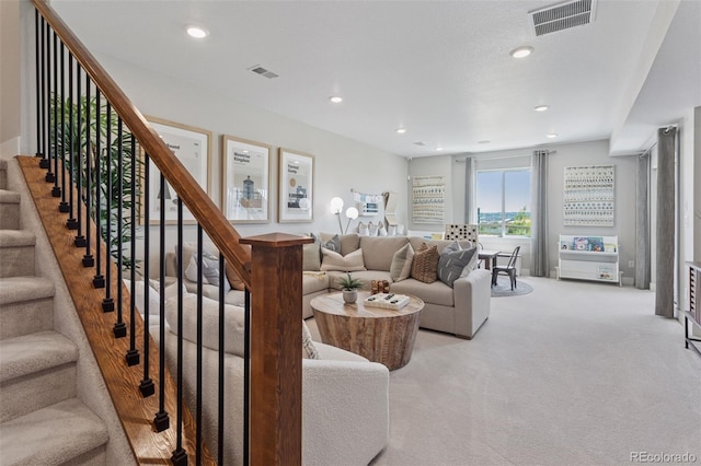 13334 Blue Amber Ct, Parker, CO 80134 - living area featuring light colored carpet, recessed lighting, and stairs