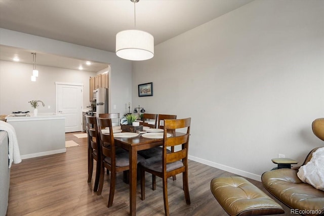 dining space with dark hardwood / wood-style flooring