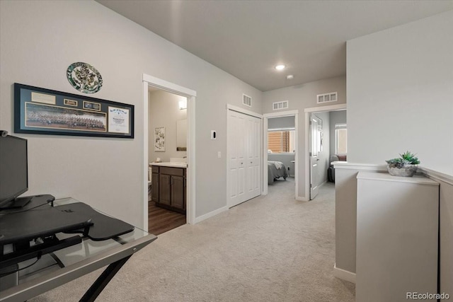 hallway featuring light carpet