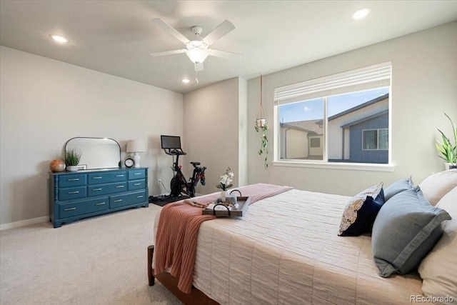 bedroom with ceiling fan and light carpet