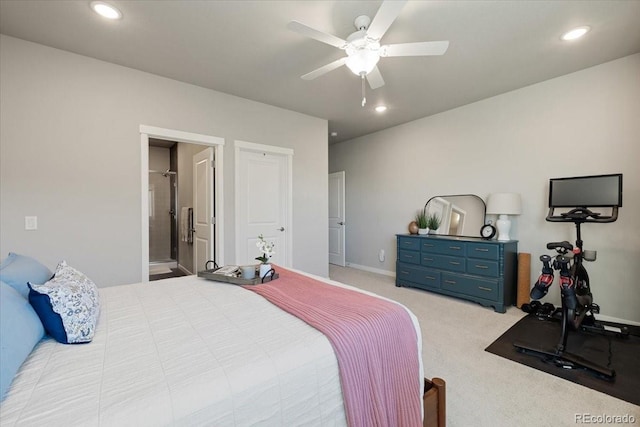 carpeted bedroom with ensuite bathroom and ceiling fan