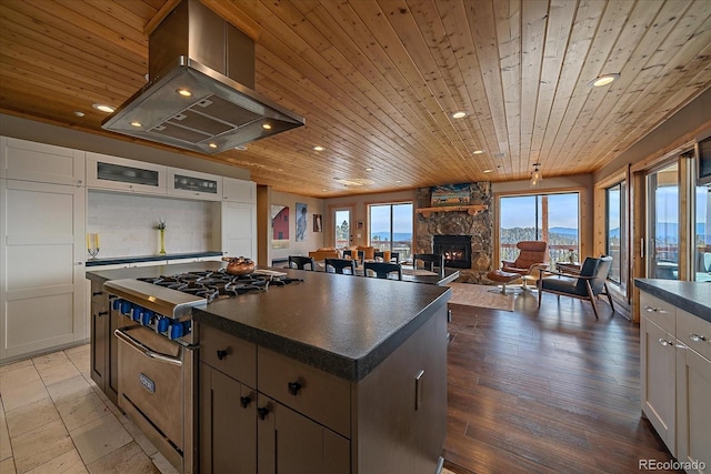 kitchen featuring wood ceiling, a kitchen island, white cabinetry, island range hood, and high end stove