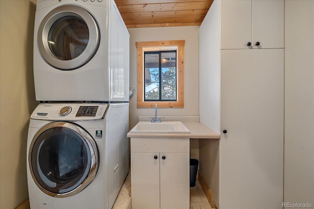 laundry area featuring wood ceiling, stacked washer / dryer, cabinets, and sink