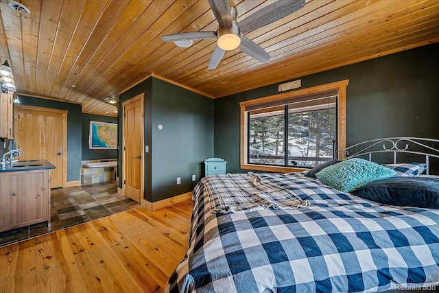 bedroom with ensuite bathroom, dark hardwood / wood-style flooring, sink, ceiling fan, and wood ceiling