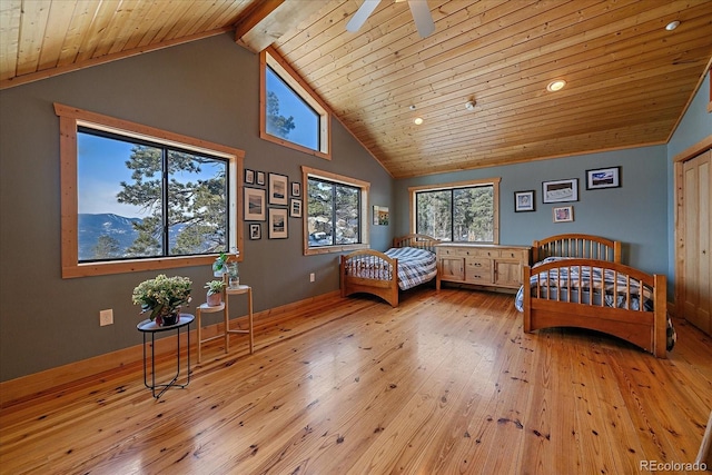 bedroom with a mountain view, light hardwood / wood-style floors, wooden ceiling, and vaulted ceiling with beams