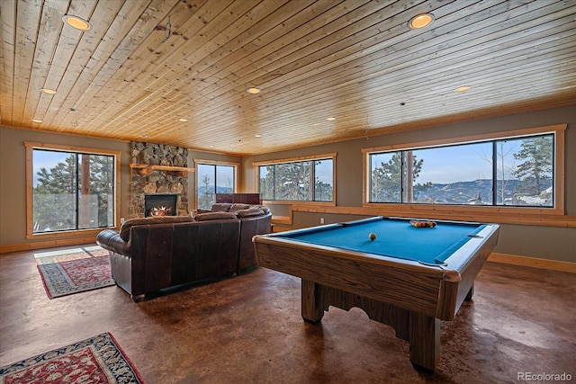 recreation room featuring a mountain view, wooden ceiling, pool table, and a stone fireplace