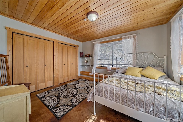 bedroom featuring wooden ceiling and two closets