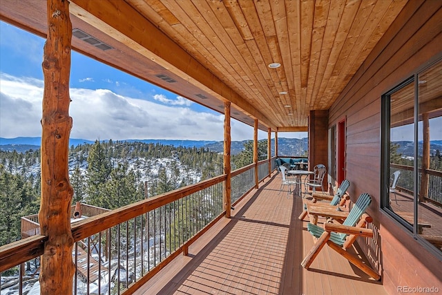 snow covered deck featuring a mountain view