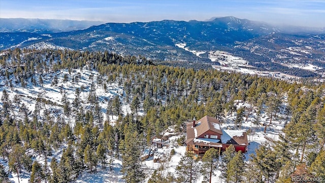 snowy aerial view with a mountain view